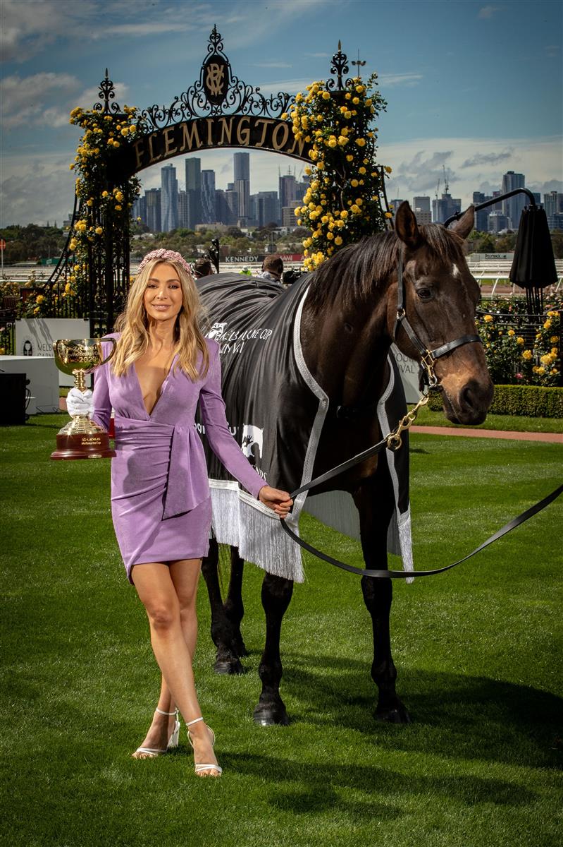 MELBOURNE, AUSTRALIA - OCTOBER 27: Melbourne Cup Carnival Ambassador Nadia Bartel poses with the Melbourne Cup and 2000 Melbourne Cup Winner 'Brew' at the Melbourne Cup Carnival launch at Flemington Racecourse on October 27, 2020 in Melbourne, Australia. (Photo by Darrian Traynor/Getty Images)