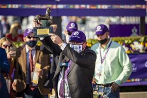 LEXINGTON, KY - NOVEMBER 07: Kirk Wycoff, the owner of Fire at Will, holds up a trophy after his horse won the Juvenile Turf for Colts and Geldings during the Breeders Cup at Keenland on November 6, 2020 in Lexington, Kentucky. (Photo by Bobby Ellis/Getty Images)