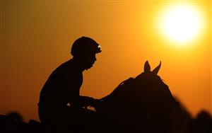 LEXINGTON, KENTUCKY - NOVEMBER 06: The sun sets on the jockeys before the start of the Breeder's Cup Juvenile during the 2020 Breeder's Cup at Keeneland on November 06, 2020 in Lexington, Kentucky. (Photo by Andy Lyons/Getty Images)