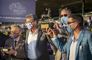 LEXINGTON, KY - NOVEMBER 07: The Aunt Pearl team poses with their colors and trophy in the winners circle after winning the Juvenile Fillies Turf race at Keenland on November 6, 2020 in Lexington, Kentucky. (Photo by Bobby Ellis/Getty Images)