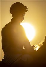 LEXINGTON, KY - NOVEMBER 07: A jockey is silhouetted by the sun on the first day of the Breeders Cup at Keenland on November 6, 2020 in Lexington, Kentucky. (Photo by Bobby Ellis/Getty Images)