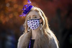 LEXINGTON, KY - NOVEMBER 07: A spectator makes her way through the paddock area at Keenland on November 6, 2020 in Lexington, Kentucky. (Photo by Bobby Ellis/Getty Images)