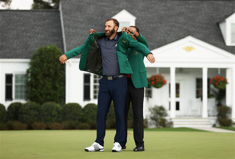Dustin Johnson is awarded the Green Jacket by Masters champion Tiger Woods during the Green Jacket Ceremony after winning the Masters at Augusta National Golf Club (Photo by Getty Images)