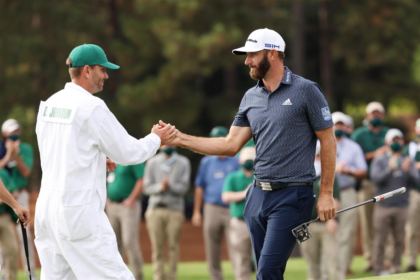 Dustin Johnson of the United States celebrates with caddie Austin Johnson on the 18th green after winning the Masters at Augusta National Golf Club (Photo by Getty Images)