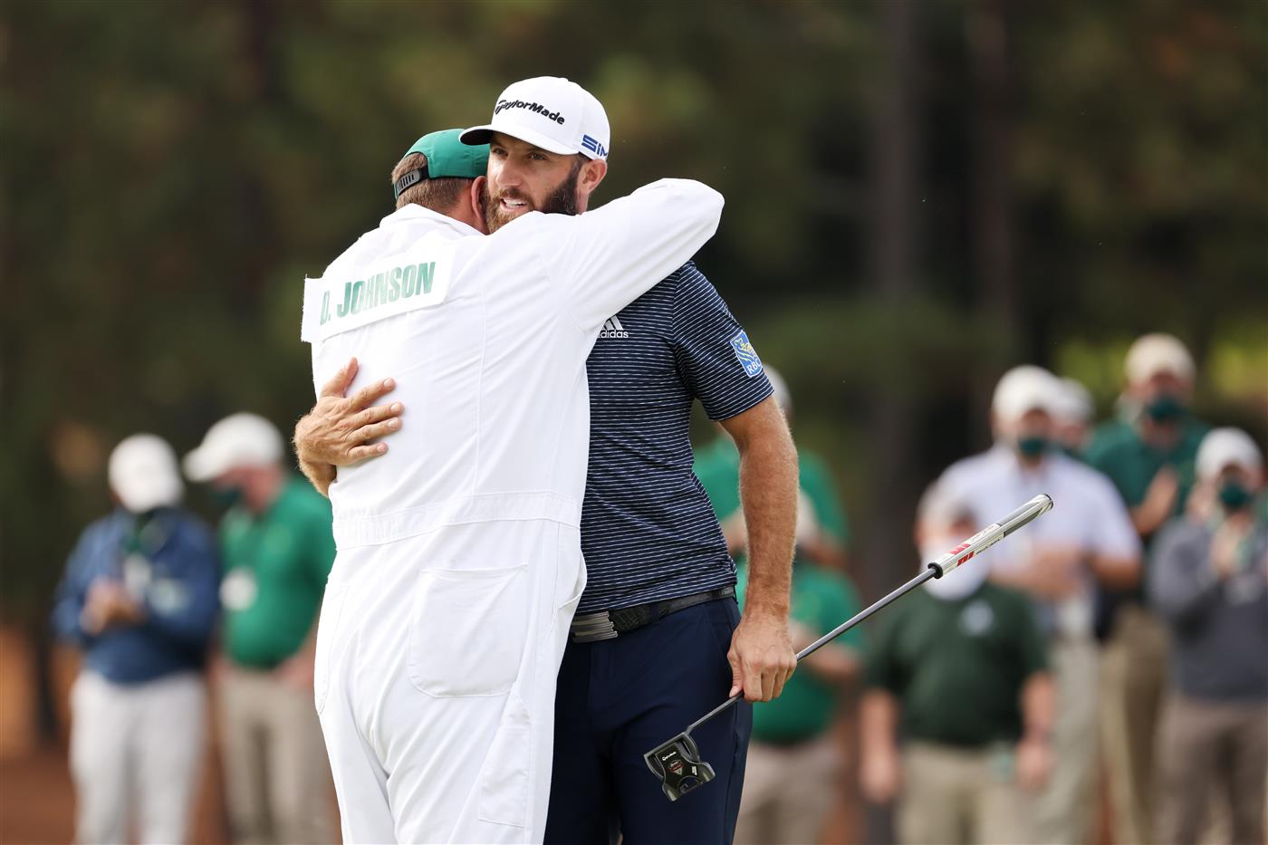 Dustin Johnson of the United States celebrates with caddie Austin Johnson on the 18th green after winning the Masters at Augusta National Golf Club (Photo by Getty Images)