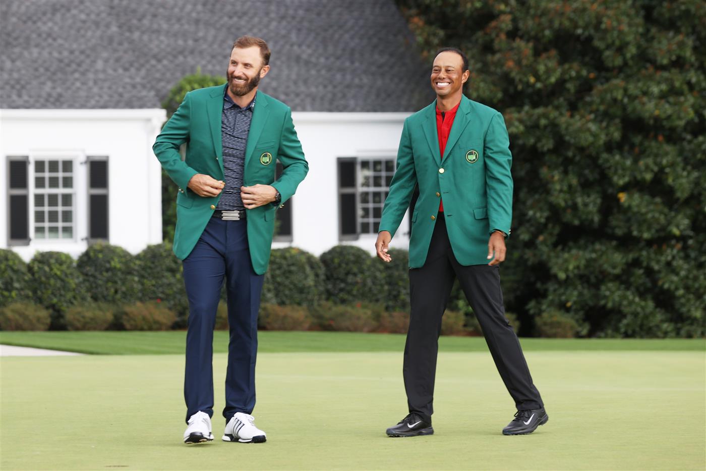 Dustin Johnson is awarded the Green Jacket by Masters champion Tiger Woods during the Green Jacket Ceremony after winning the Masters at Augusta National Golf Club (Photo by Getty Images)