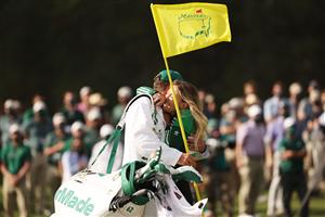 Paulina Gretzky, fiancée of Dustin Johnson of the United States (not pictured), celebrates with caddie Austin Johnson on the 18th green after Dustin Johnson won the Masters at Augusta National Golf Club (Photo by Getty Images)
