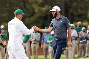 Dustin Johnson of the United States celebrates with caddie Austin Johnson on the 18th green after winning the Masters at Augusta National Golf Club (Photo by Getty Images)