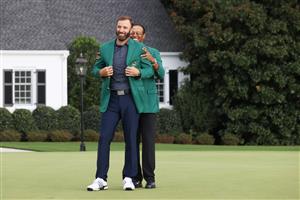 Dustin Johnson is awarded the Green Jacket by Masters champion Tiger Woods during the Green Jacket Ceremony after winning the Masters at Augusta National Golf Club (Photo by Getty Images)