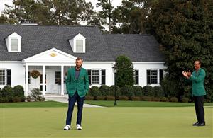 Dustin Johnson is awarded the Green Jacket by Masters champion Tiger Woods during the Green Jacket Ceremony after winning the Masters at Augusta National Golf Club (Photo by Getty Images)