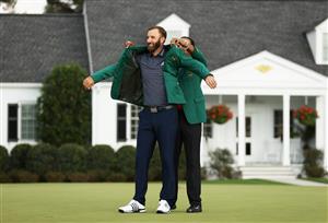 Dustin Johnson is awarded the Green Jacket by Masters champion Tiger Woods during the Green Jacket Ceremony after winning the Masters at Augusta National Golf Club (Photo by Getty Images)