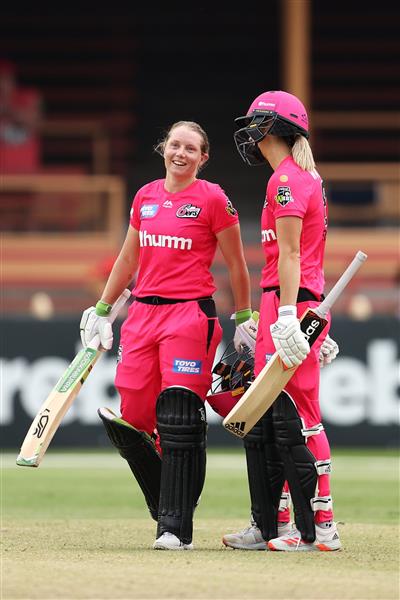 SYDNEY, AUSTRALIA - NOVEMBER 22: Alyssa Healy of the Sixers celebrates scoring a century with team mate Ellyse Perry of the Sixers during the Women's Big Bash League WBBL match between the Melbourne Stars and the Sydney Sixers at North Sydney Oval, on November 22, 2020, in Sydney, Australia. (Photo by Cameron Spencer/Getty Images)