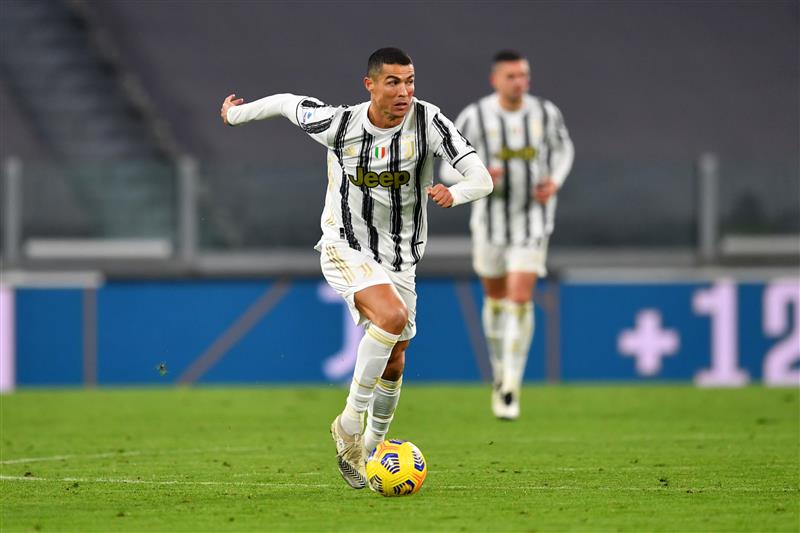 TURIN, ITALY - NOVEMBER 21: Cristiano Ronaldo of Juventus runs with the ball during the Serie A match between Juventus and Cagliari Calcio at  on November 21, 2020 in Turin, Italy. Football Stadiums around Europe remain empty due to the Coronavirus Pandemic as Government social distancing laws prohibit fans inside venues resulting in fixtures being played behind closed doors. (Photo by Valerio Pennicino/Getty Images)