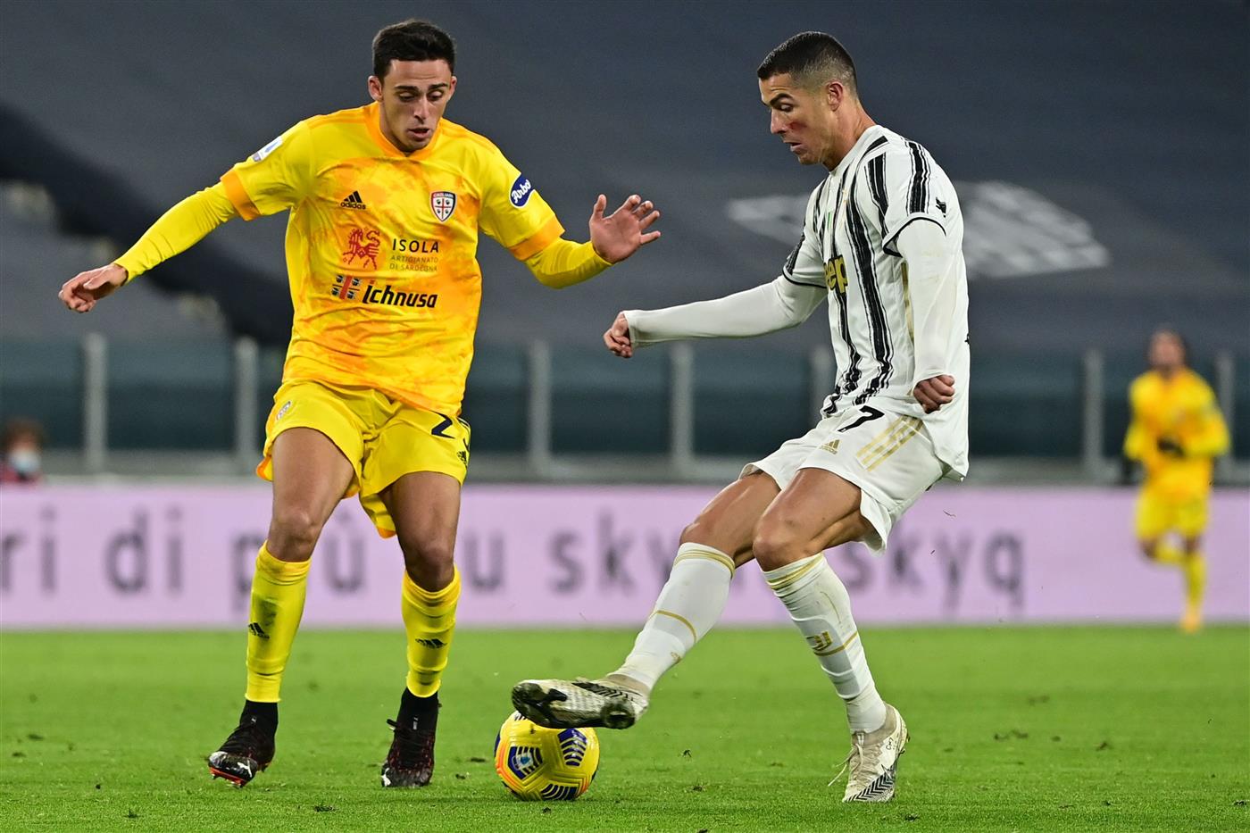 Portuguese forward Cristiano Ronaldo challenges Cagliari's Italian defender Gabriele Zappa (L) during the Italian Serie A football match Juventus vs Cagliari on November 21, 2020 at the Juventus stadium in Turin. (Photo by MIGUEL MEDINA / AFP) (Photo by MIGUEL MEDINA/AFP via Getty Images)