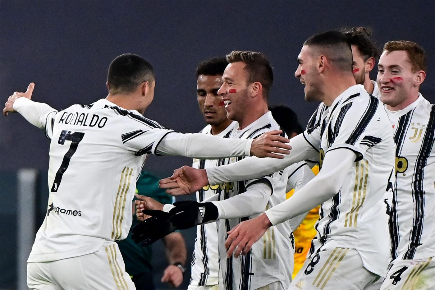 Portuguese forward Cristiano Ronaldo (L) celebrates with Juventus' Brazilian midfielder Arthur (C) and teammates after opening the scoring during the Italian Serie A football match Juventus vs Cagliari on November 21, 2020 at the Juventus stadium in Turin. (Photo by MIGUEL MEDINA / AFP) (Photo by MIGUEL MEDINA/AFP via Getty Images)