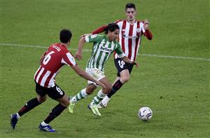 BILBAO, SPAIN - NOVEMBER 23: Diego Lainez of Real Betis is challenged by Oihan Sancet and Mikel Vesga of Athletic Bilbao during the La Liga Santander match between Athletic Club and Real Betis at Estadio de San Mames on November 23, 2020 in Bilbao, Spain. Sporting stadiums around Spain remain under strict restrictions due to the Coronavirus Pandemic as Government social distancing laws prohibit fans inside venues resulting in games being played behind closed doors. (Photo by Juan Manuel Serrano Arce/Getty Images)