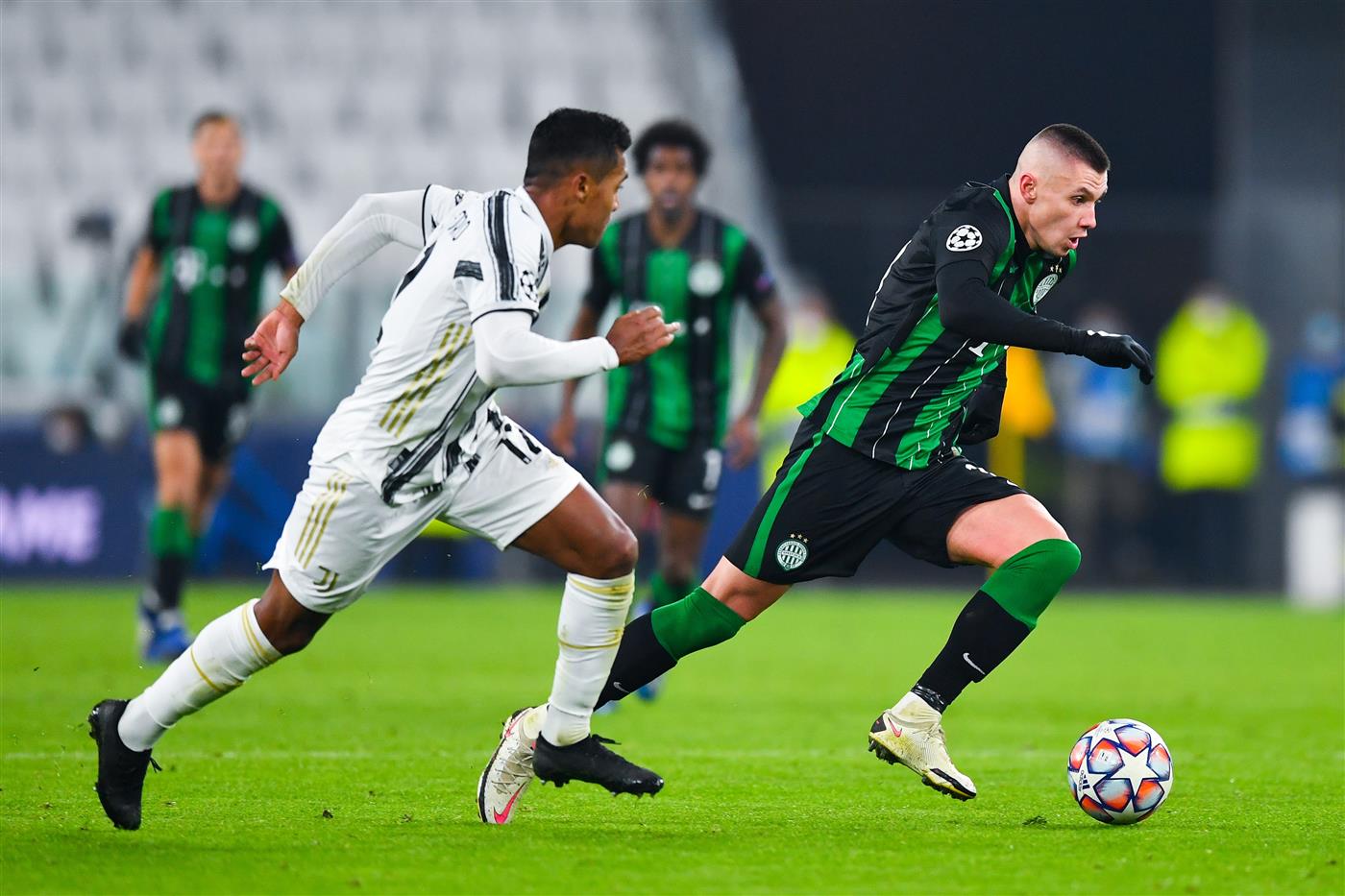 TURIN, ITALY - NOVEMBER 24: Alex Sandro of Juventus AF.C. and Oleksandr Zubkov of Ferencvaros battle for the ball during the UEFA Champions League Group G stage match between Juventus and Ferencvaros Budapest at Allianz Stadium on November 24, 2020 in Turin, Italy. Sporting stadiums around Italy remain under strict restrictions due to the Coronavirus Pandemic as Government social distancing laws prohibit fans inside venues resulting in games being played behind closed doors. (Photo by Valerio Pennicino/Getty Images)