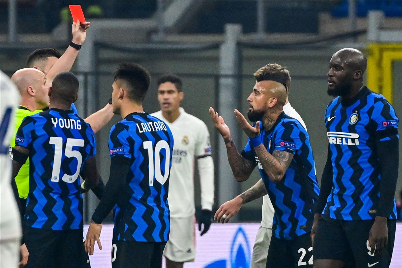 English referee Anthony Taylor (L) shows a red card to Inter Milan