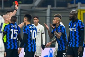 English referee Anthony Taylor (L) shows a red card to Inter Milan