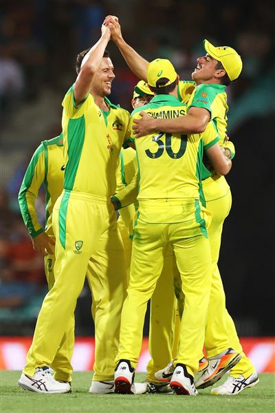 SYDNEY, AUSTRALIA - NOVEMBER 29: Josh Hazlewood of Australia celebrates with Moises Henriques of Australia after dismissing Virat Kohli of India during game two of the One Day International series between Australia and India at Sydney Cricket Ground on November 29, 2020 in Sydney, Australia. (Photo by Cameron Spencer/Getty Images)
