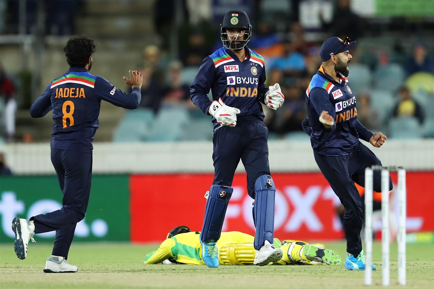 CANBERRA, AUSTRALIA - DECEMBER 02: Ravindra Jadeja, KL Rahul and Virat Kohli of India celebrates the run out of Alex Carey of Australia during game three of the One Day International series between Australia and India at Manuka Oval on December 02, 2020 in Canberra, Australia. (Photo by Mark Kolbe/Getty Images)