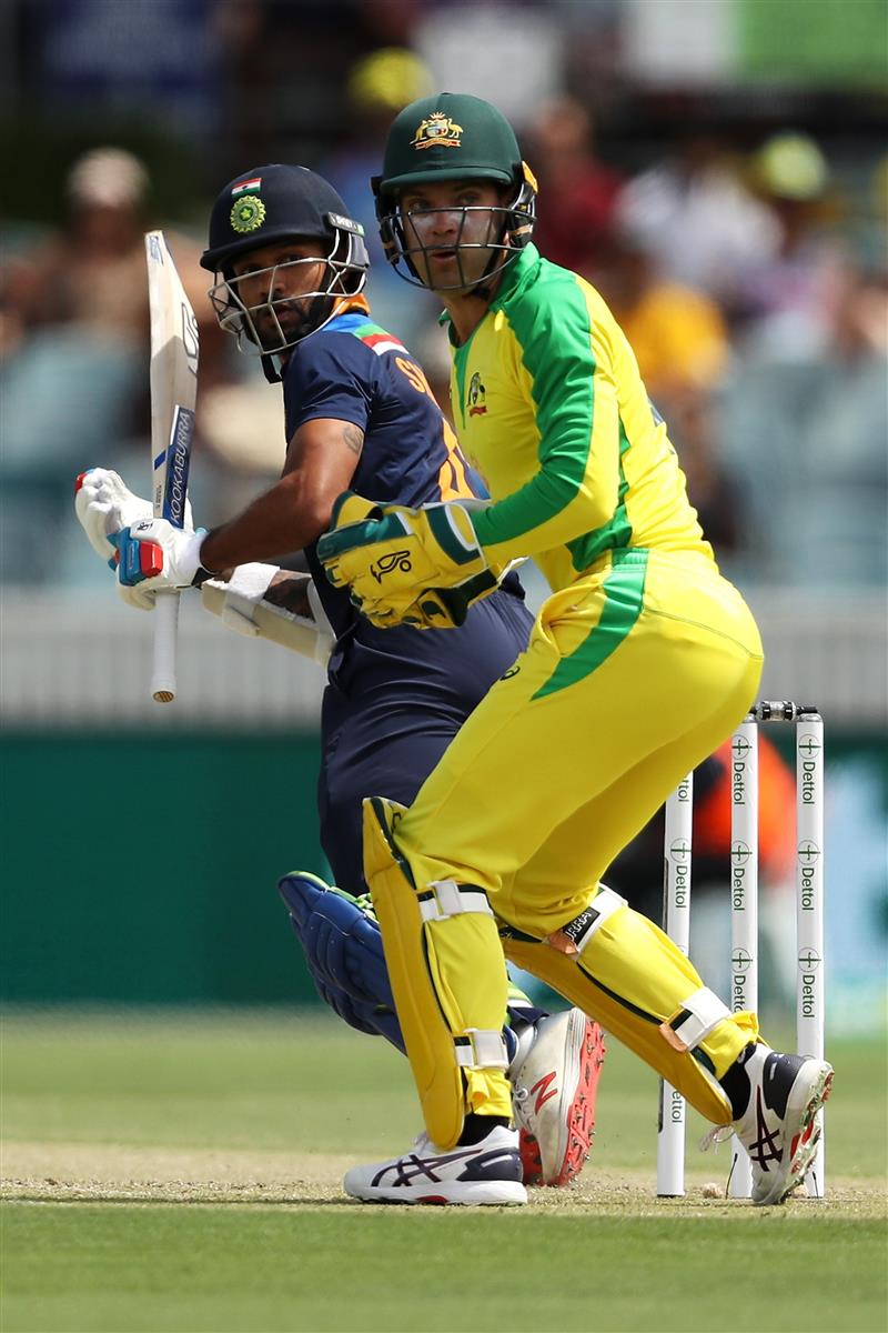 CANBERRA, AUSTRALIA - DECEMBER 02: Shikhar Dhawan of India and Alex Carey of Australia watch the ball during game three of the One Day International series between Australia and India at Manuka Oval on December 02, 2020 in Canberra, Australia. (Photo by Mark Kolbe/Getty Images)