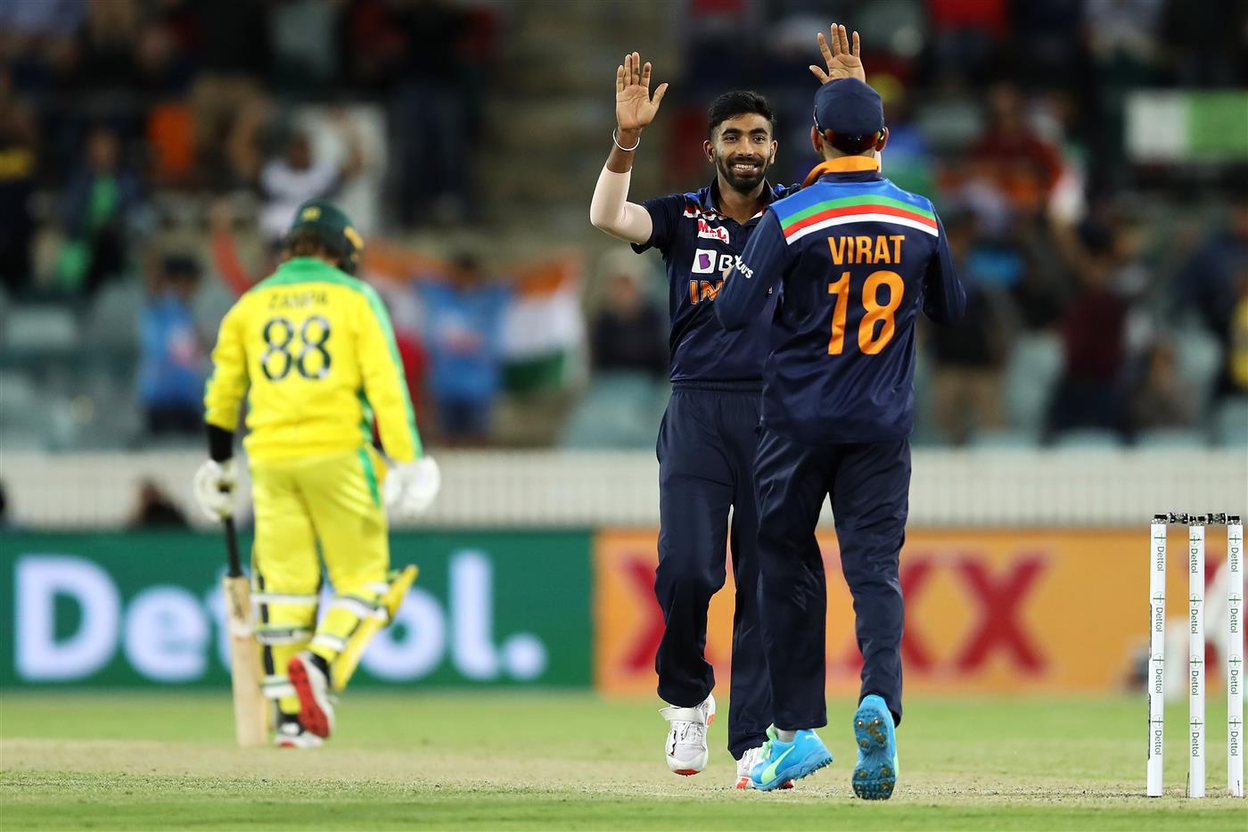 CANBERRA, AUSTRALIA - DECEMBER 02: Jasprit Bumrah and Virat Kohli of India celebrate victory during game three of the One Day International series between Australia and India at Manuka Oval on December 02, 2020 in Canberra, Australia. (Photo by Mark Kolbe/Getty Images)