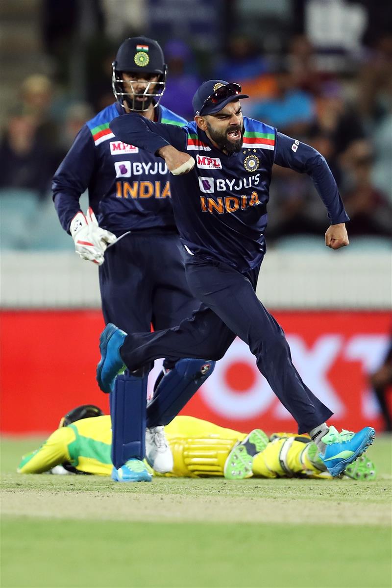 CANBERRA, AUSTRALIA - DECEMBER 02: (EDITORS NOTE: Retransmission with alternate crop.) Virat Kohli of India celebrates the run out of Alex Carey of Australia during game three of the One Day International series between Australia and India at Manuka Oval on December 02, 2020 in Canberra, Australia. (Photo by Mark Kolbe/Getty Images)