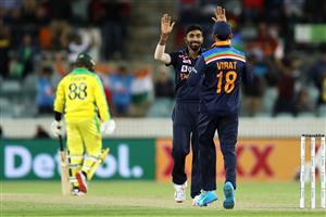 CANBERRA, AUSTRALIA - DECEMBER 02: Jasprit Bumrah and Virat Kohli of India celebrate victory during game three of the One Day International series between Australia and India at Manuka Oval on December 02, 2020 in Canberra, Australia. (Photo by Mark Kolbe/Getty Images)
