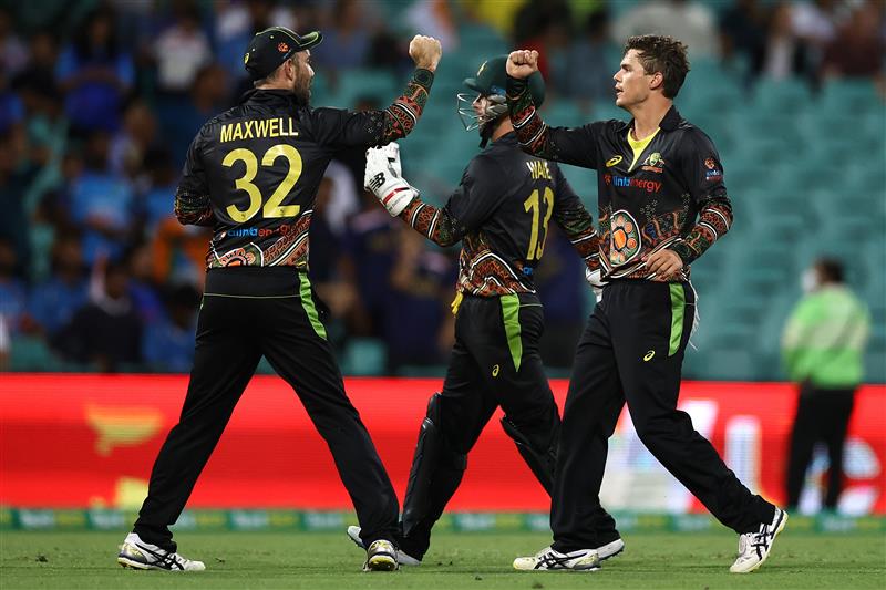 SYDNEY, AUSTRALIA - DECEMBER 06: Mitch Swepson of Australia is congratulated by team mates after getting the wicket of Sanju Samson of India during game two of the Twenty20 International series between Australia and India at Sydney Cricket Ground on December 06, 2020 in Sydney, Australia. (Photo by Ryan Pierse/Getty Images)