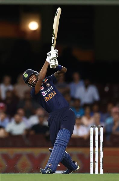 SYDNEY, AUSTRALIA - DECEMBER 06: Hardik Pandya of India hits a six to win game two of the Twenty20 International series between Australia and India at Sydney Cricket Ground on December 06, 2020 in Sydney, Australia. (Photo by Ryan Pierse/Getty Images)