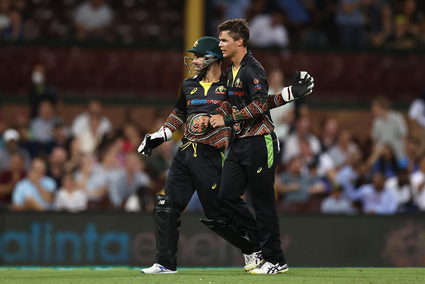 SYDNEY, AUSTRALIA - DECEMBER 06: Mitch Swepson of Australia is congratulated by Matthew Wade after getting the wicket of Sanju Samson of India during game two of the Twenty20 International series between Australia and India at Sydney Cricket Ground on December 06, 2020 in Sydney, Australia. (Photo by Ryan Pierse/Getty Images)