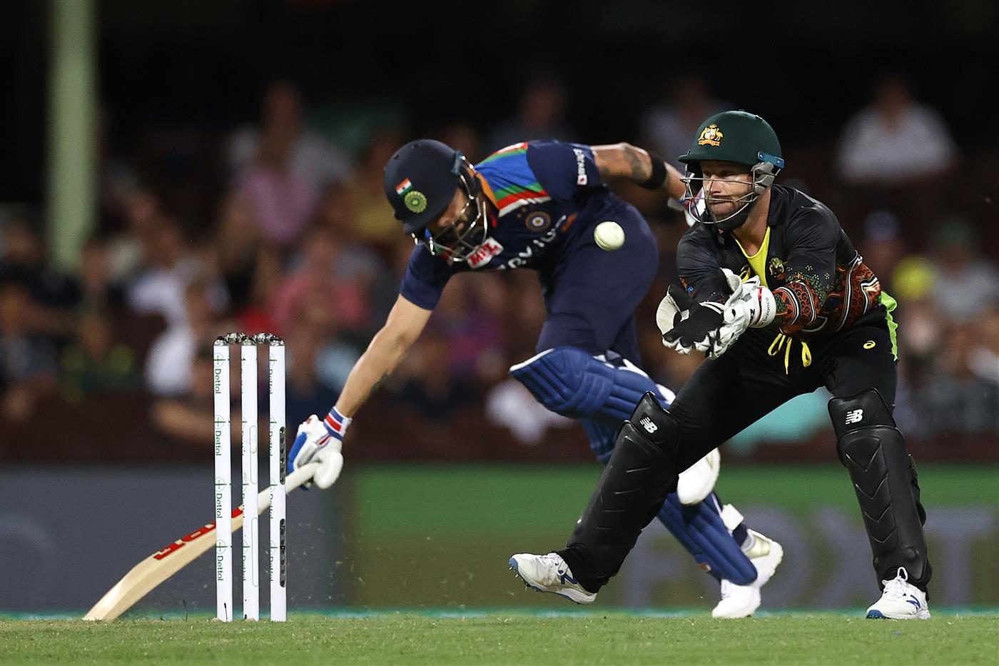 SYDNEY, AUSTRALIA - DECEMBER 06: Matthew Wade of Australia takes the ball as Virat Kohli of India stretches to make a run during game two of the Twenty20 International series between Australia and India at Sydney Cricket Ground on December 06, 2020 in Sydney, Australia. (Photo by Ryan Pierse/Getty Images)