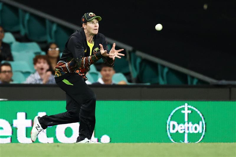 SYDNEY, AUSTRALIA - DECEMBER 08: Steve Smith of Australia catches Sanju Samson of India off a delivery by Mitchell Swepson of Australia during game three of the Twenty20 International series between Australia and India at Sydney Cricket Ground on December 08, 2020 in Sydney, Australia. (Photo by Cameron Spencer/Getty Images)