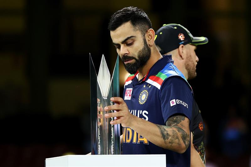 SYDNEY, AUSTRALIA - DECEMBER 08: Virat Kohli of India collects the T20 Trophy following game three of the Twenty20 International series between Australia and India at Sydney Cricket Ground on December 08, 2020 in Sydney, Australia. (Photo by Cameron Spencer/Getty Images)