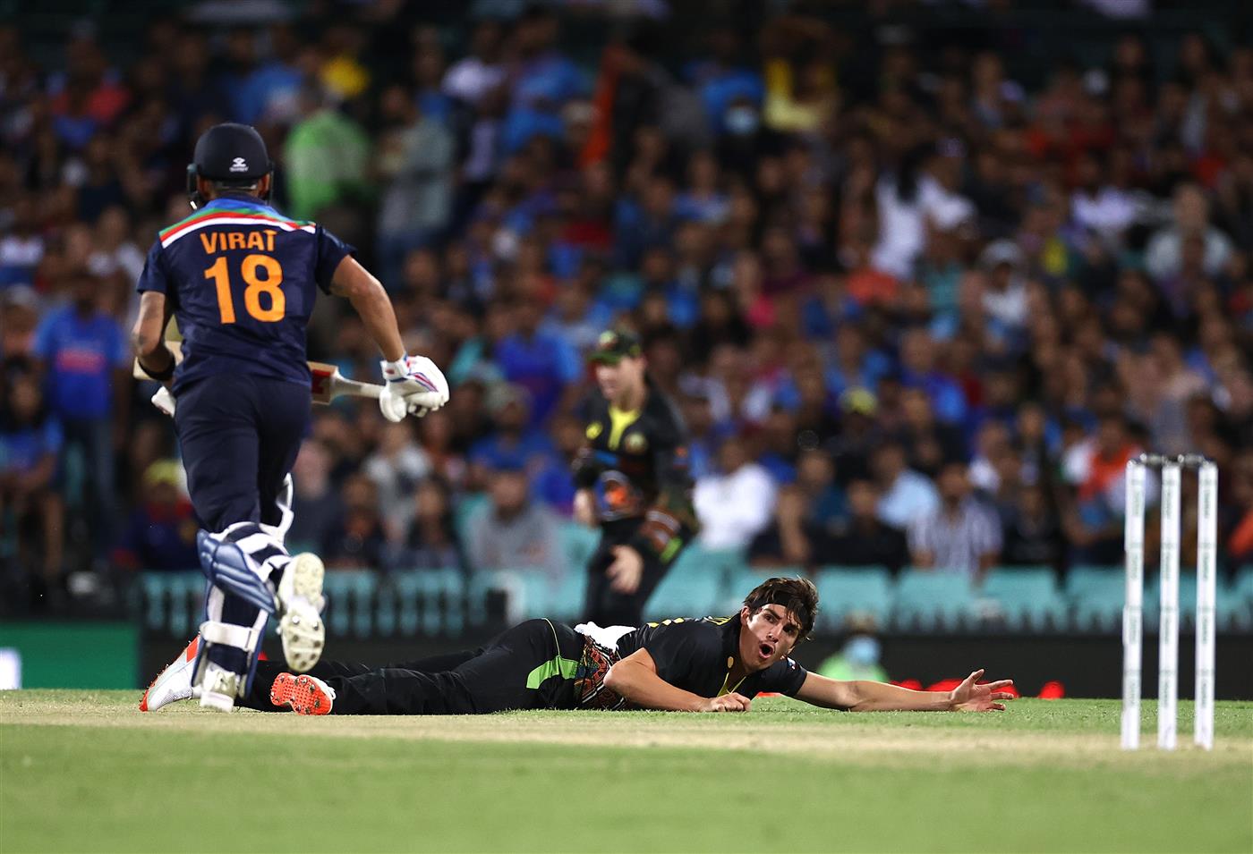 SYDNEY, AUSTRALIA - DECEMBER 08: Sean Abbott of Australia reacts after diving to field the ball during game three of the Twenty20 International series between Australia and India at Sydney Cricket Ground on December 08, 2020 in Sydney, Australia. (Photo by Ryan Pierse/Getty Images)