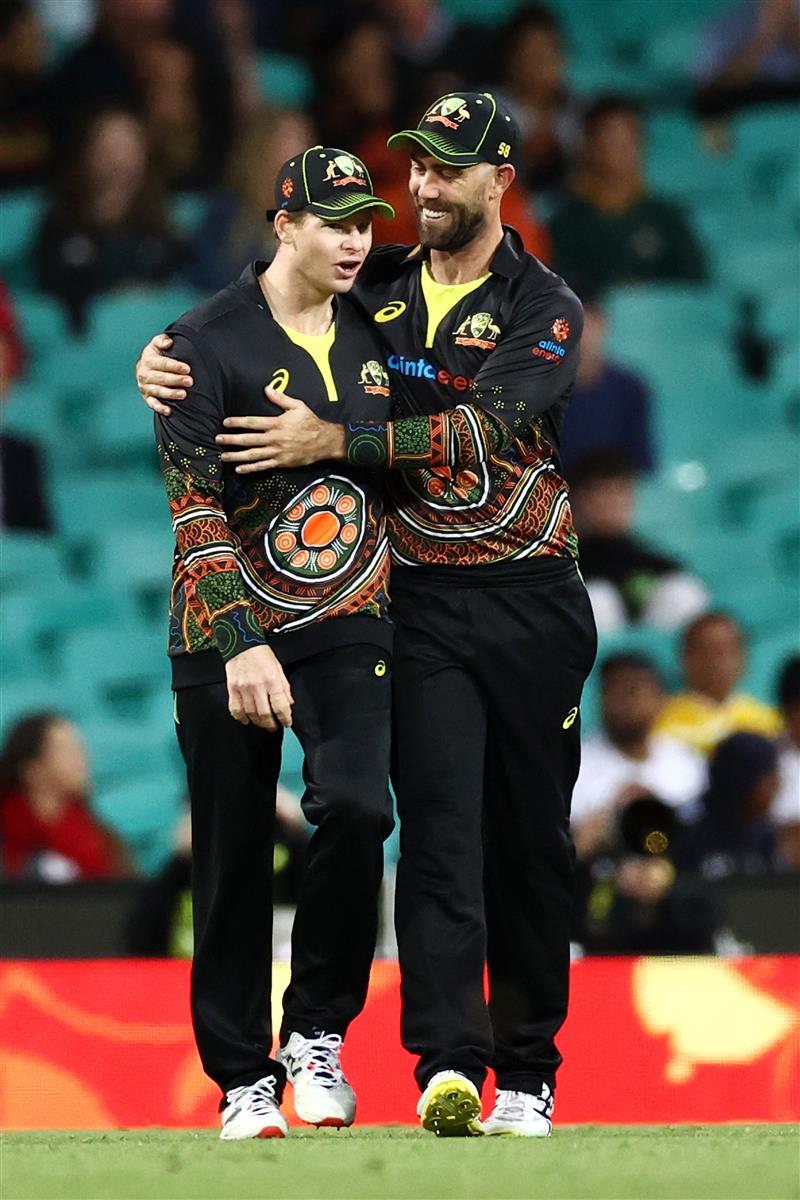 SYDNEY, AUSTRALIA - DECEMBER 08: Steve Smith of Australia is congratulated by Glenn Maxwell of Australia after catching Sanju Samson of India during game three of the Twenty20 International series between Australia and India at Sydney Cricket Ground on December 08, 2020 in Sydney, Australia. (Photo by Cameron Spencer/Getty Images)