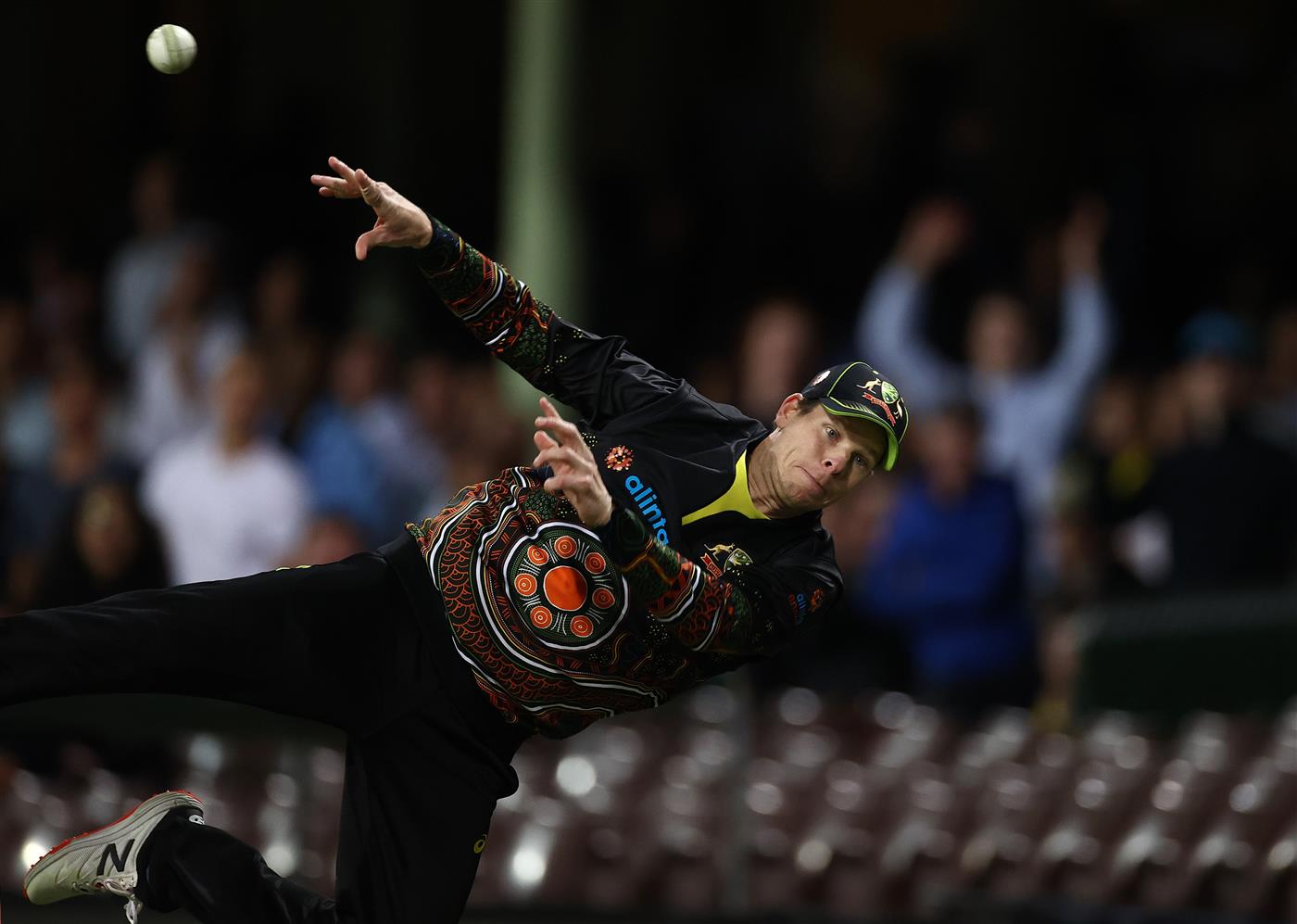 SYDNEY, AUSTRALIA - DECEMBER 08:  Steve Smith of Australia dives to stop a boundary during game three of the Twenty20 International series between Australia and India at Sydney Cricket Ground on December 08, 2020 in Sydney, Australia. (Photo by Ryan Pierse/Getty Images)