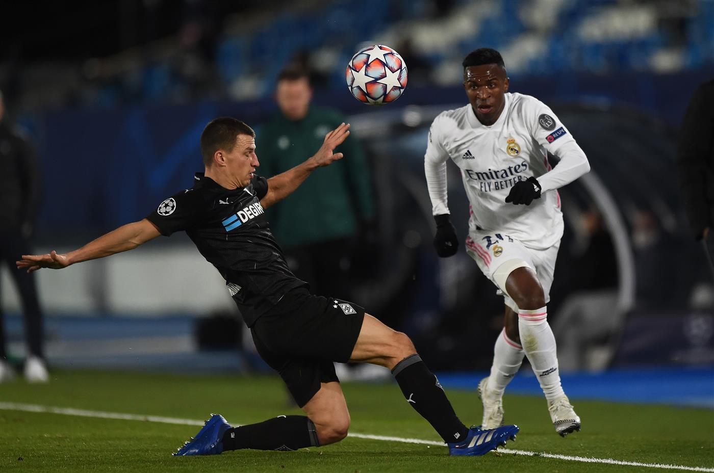MADRID, SPAIN - DECEMBER 09:  Vinicius Junior of Real Madrid gets past Stefan Lainer of Borussia Moenchengladbach during the UEFA Champions League Group B stage match between Real Madrid and Borussia Moenchengladbach at Estadio Alfredo di Stefano on December 09, 2020 in Madrid, Spain. Sporting stadiums around Spain remain under strict restrictions due to the Coronavirus Pandemic as Government social distancing laws prohibit fans inside venues resulting in games being played behind closed doors. (Photo by Denis Doyle/Getty Images)
