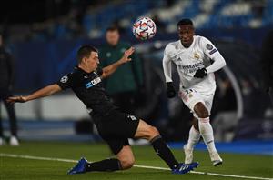 MADRID, SPAIN - DECEMBER 09: Vinicius Junior of Real Madrid gets past Stefan Lainer of Borussia Moenchengladbach during the UEFA Champions League Group B stage match between Real Madrid and Borussia Moenchengladbach at Estadio Alfredo di Stefano on December 09, 2020 in Madrid, Spain. Sporting stadiums around Spain remain under strict restrictions due to the Coronavirus Pandemic as Government social distancing laws prohibit fans inside venues resulting in games being played behind closed doors. (Photo by Denis Doyle/Getty Images)