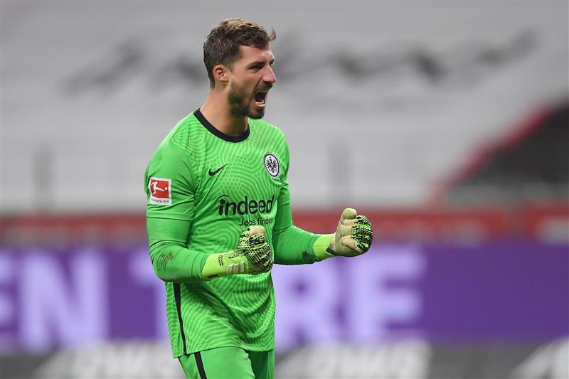 FRANKFURT AM MAIN, GERMANY - DECEMBER 15: Kevin Trapp of Eintracht Frankfurt celebrates their sides first goal during the Bundesliga match between Eintracht Frankfurt and Borussia Moenchengladbach at Deutsche Bank Park on December 15, 2020 in Frankfurt am Main, Germany. Sporting stadiums around Germany remain under strict restrictions due to the Coronavirus Pandemic as Government social distancing laws prohibit fans inside venues resulting in games being played behind closed doors. (Photo by Alexander Scheuber/Getty Images)