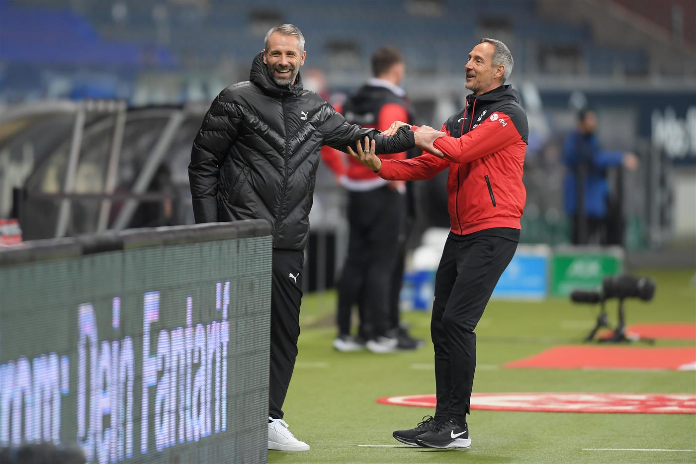 FRANKFURT AM MAIN, GERMANY - DECEMBER 15: Adi Hutter, Head Coach of Eintracht Frankfurt shares a joke with Marco Rose, Head Coach of Borussia Monchengladbach prior to the Bundesliga match between Eintracht Frankfurt and Borussia Moenchengladbach at Deutsche Bank Park on December 15, 2020 in Frankfurt am Main, Germany. Sporting stadiums around Germany remain under strict restrictions due to the Coronavirus Pandemic as Government social distancing laws prohibit fans inside venues resulting in games being played behind closed doors. (Photo by Alexander Scheuber/Getty Images)