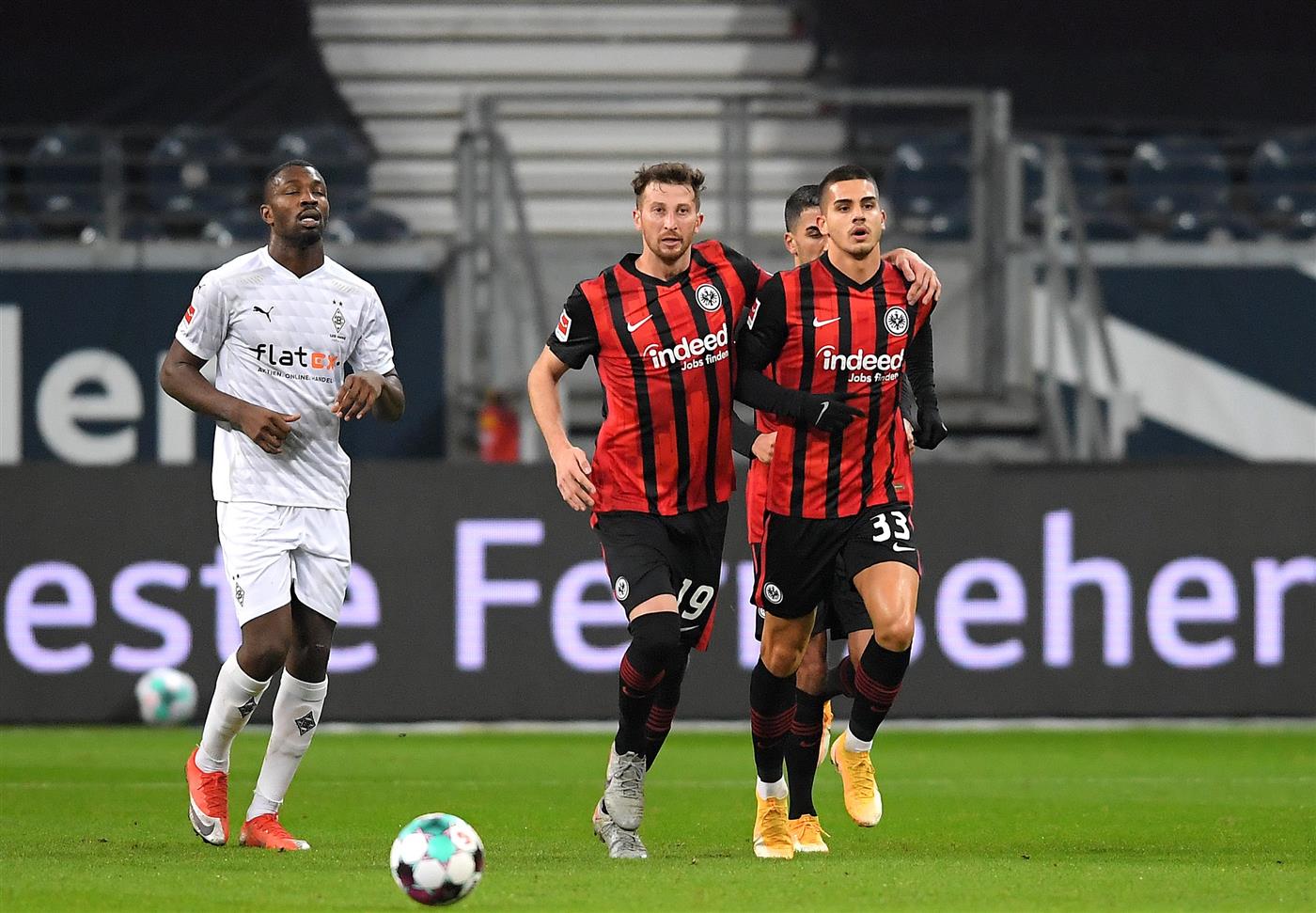 FRANKFURT AM MAIN, GERMANY - DECEMBER 15: Andre Silva of Eintracht Frankfurt celebrates with teammate David Abraham after scoring his sides first goal during the Bundesliga match between Eintracht Frankfurt and Borussia Moenchengladbach at Deutsche Bank Park on December 15, 2020 in Frankfurt am Main, Germany. Sporting stadiums around Germany remain under strict restrictions due to the Coronavirus Pandemic as Government social distancing laws prohibit fans inside venues resulting in games being played behind closed doors. (Photo by Alexander Scheuber/Getty Images)