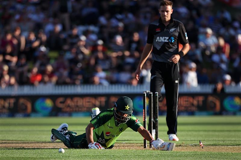 HAMILTON, NEW ZEALAND - DECEMBER 20: Mohammad Hafeez of Pakistan slides into the crease with Tim Southee of New Zealand 
 (R) during game two of the International T20 series between New Zealand and Pakistan at Seddon Park on December 20, 2020 in Hamilton, New Zealand. (Photo by Fiona Goodall/Getty Images)