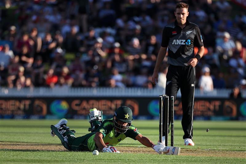 HAMILTON, NEW ZEALAND - DECEMBER 20: Mohammad Hafeez of Pakistan slides into the crease with Tim Southee of New Zealand 
 (R) during game two of the International T20 series between New Zealand and Pakistan at Seddon Park on December 20, 2020 in Hamilton, New Zealand. (Photo by Fiona Goodall/Getty Images)