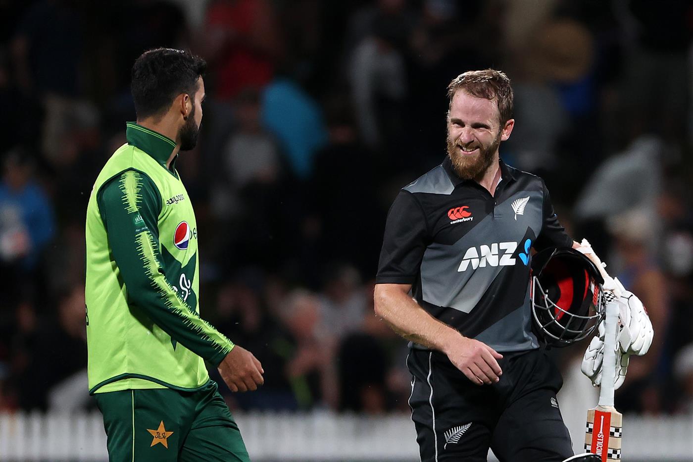 HAMILTON, NEW ZEALAND - DECEMBER 20: Shadab Khan captain of Pakistan (L) speaks to Kane Williamson, captain of New Zealand  
 at the end of the match during game two of the International T20 series between New Zealand and Pakistan at Seddon Park on December 20, 2020 in Hamilton, New Zealand. (Photo by Fiona Goodall/Getty Images)