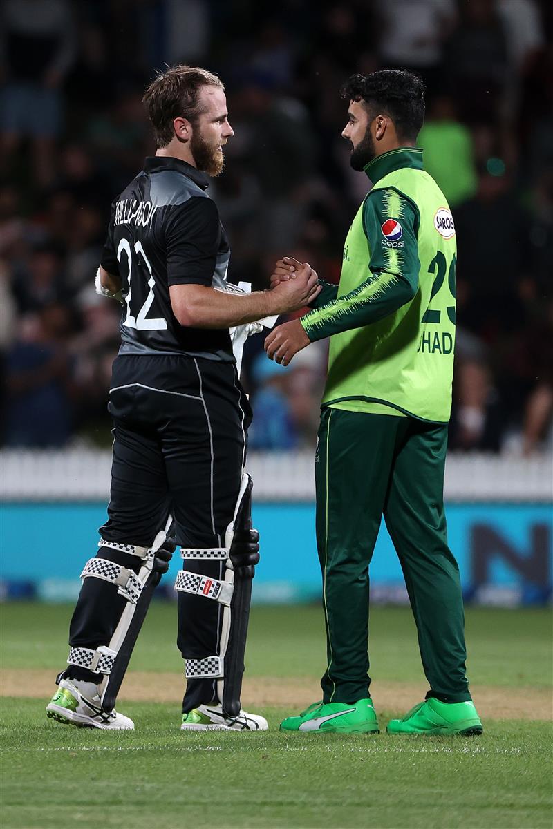 HAMILTON, NEW ZEALAND - DECEMBER 20: Shadab Khan captain of Pakistan (R) speaks to Kane Williamson, captain of New Zealand  during game two of the International T20 series between New Zealand and Pakistan at Seddon Park on December 20, 2020 in Hamilton, New Zealand. (Photo by Fiona Goodall/Getty Images)