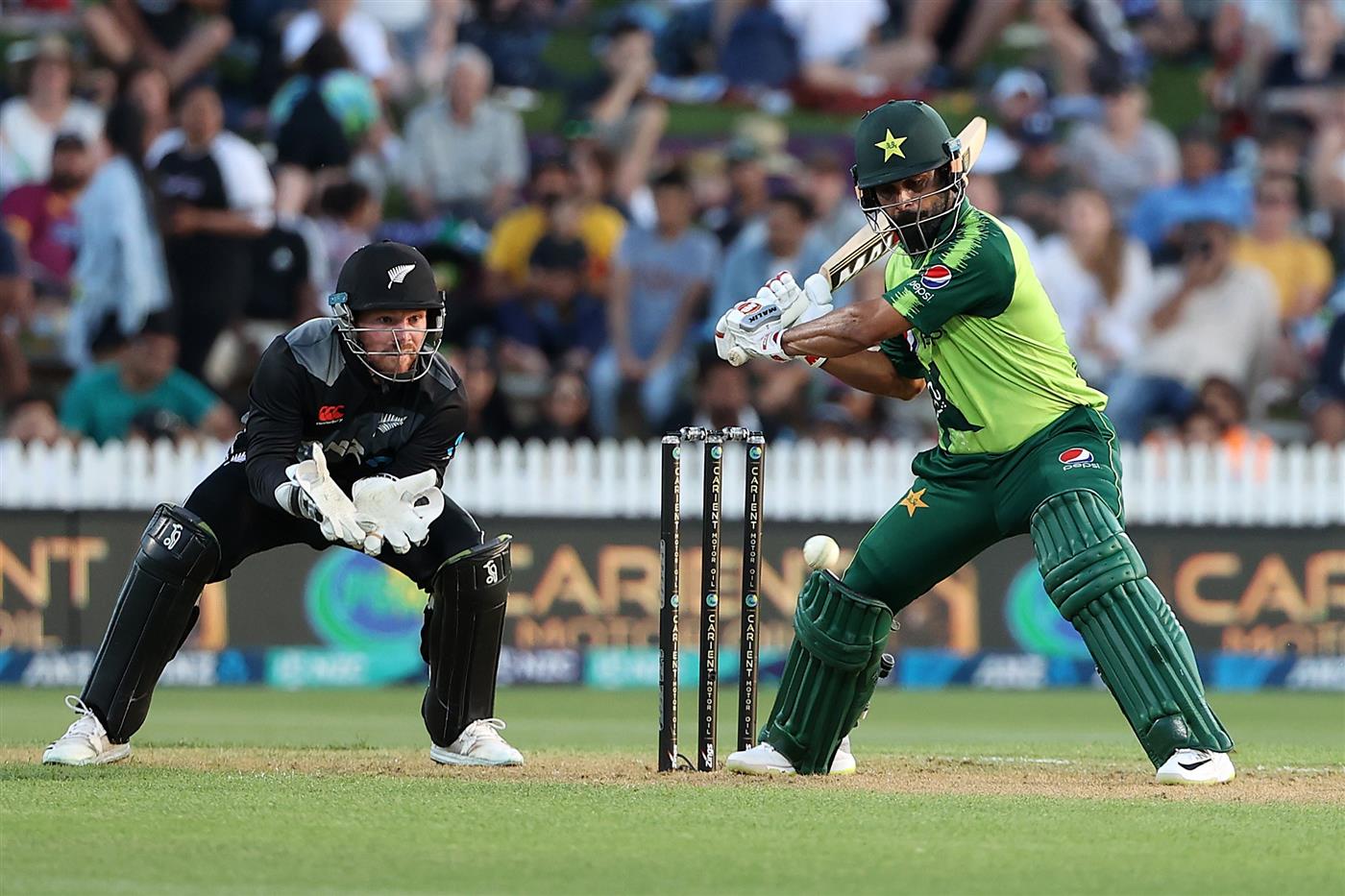 HAMILTON, NEW ZEALAND - DECEMBER 20: Mohammad Hafeez of Pakistan takes a shot with Tim Seifert of New Zealand (L) during game two of the International T20 series between New Zealand and Pakistan at Seddon Park on December 20, 2020 in Hamilton, New Zealand. (Photo by Fiona Goodall/Getty Images)