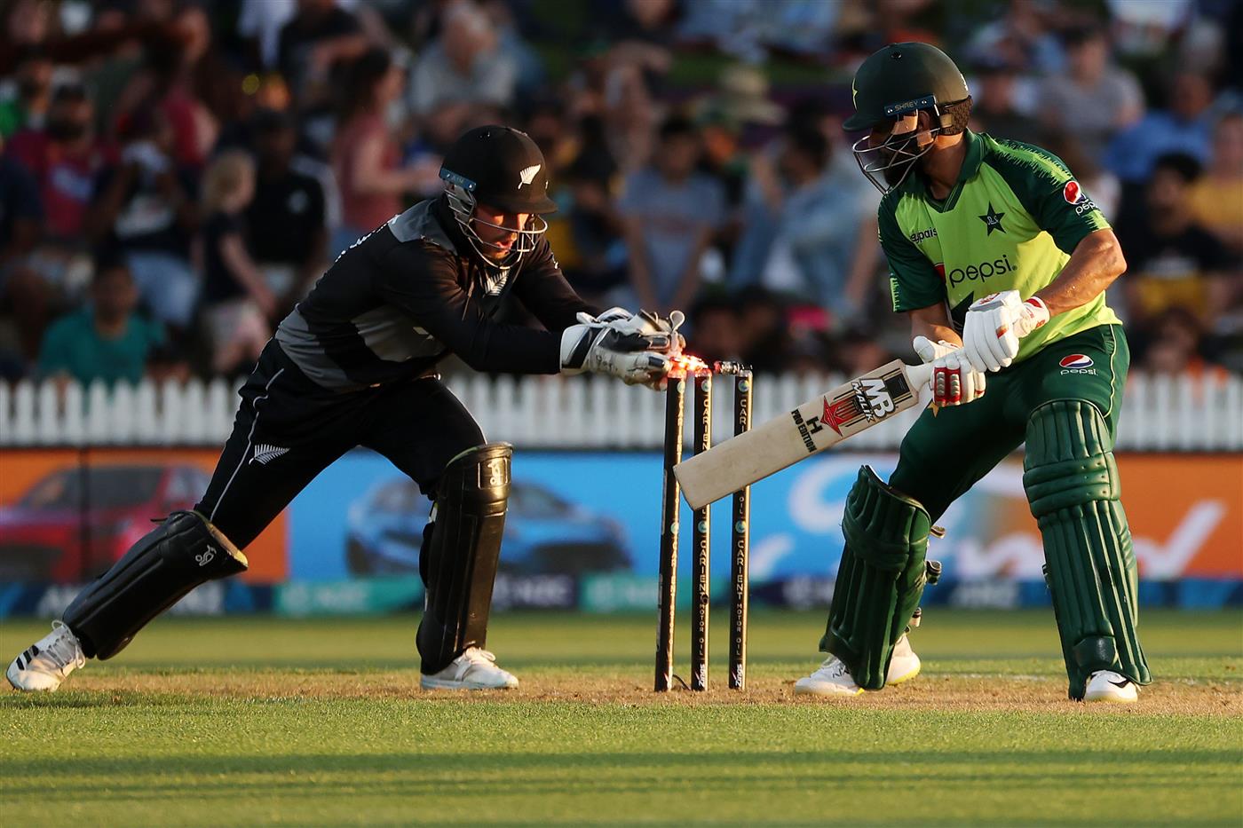 HAMILTON, NEW ZEALAND - DECEMBER 20: Mohammad Hafeez of Pakistan swings with Tim Seifert of New Zealand (L) taking the ball during the game two of the International T20 series between New Zealand and Pakistan at Seddon Park on December 20, 2020 in Hamilton, New Zealand. (Photo by Fiona Goodall/Getty Images)