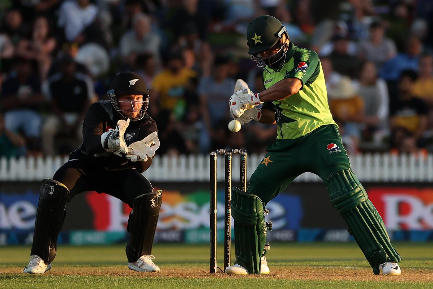 HAMILTON, NEW ZEALAND - DECEMBER 20: Mohammad Hafeez of Pakistan swings with Tim Seifert of New Zealand (L) taking the ball during the game two of the International T20 series between New Zealand and Pakistan at Seddon Park on December 20, 2020 in Hamilton, New Zealand. (Photo by Fiona Goodall/Getty Images)